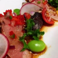 Peppered Tuna & Salmon Tataki · Spicy. 3 pieces each. Served with Japanese dressing, dry seaweed, and red onion.