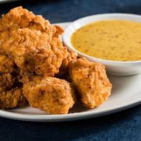 Buttermilk Chicken Bites · Tender chicken breast, marinated in buttermilk & Texas Pete hot sauce, tossed in seasoned fl...