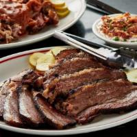 Texas Beef Brisket · Rubbed with salt & pepper and hickory smoked. Choose half pound or pound.