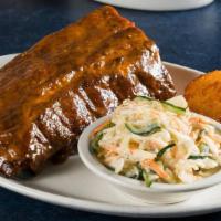 Full Rack Memphis Baby Back Ribs Meal · Dry rubbed and cherry smoked. Full rack.  Served with a corn muffin and choice of side.