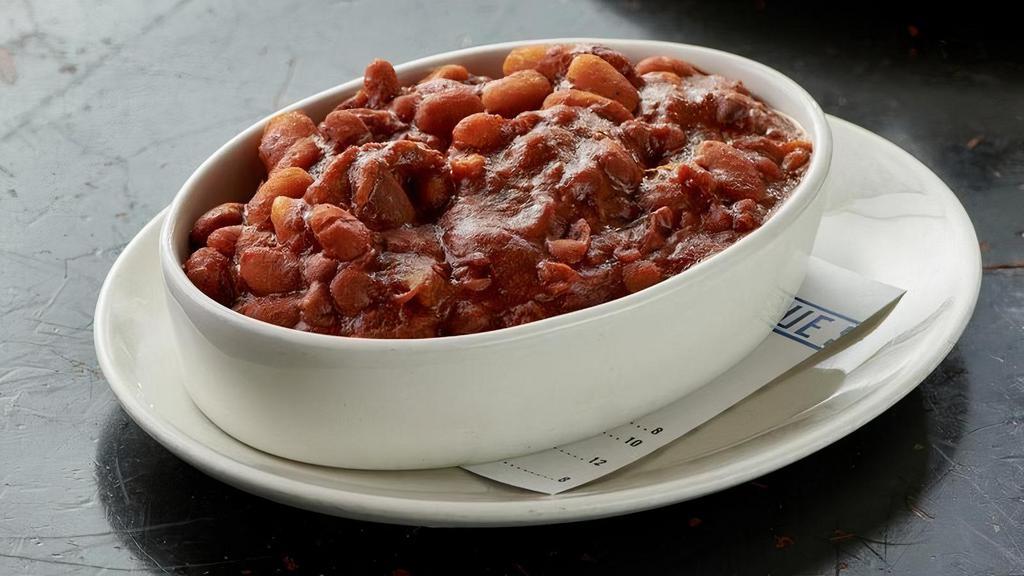 Pit Beans · Slow cooked pinto and cannellini beans simmered with smoked pork, molasses and brown sugar.