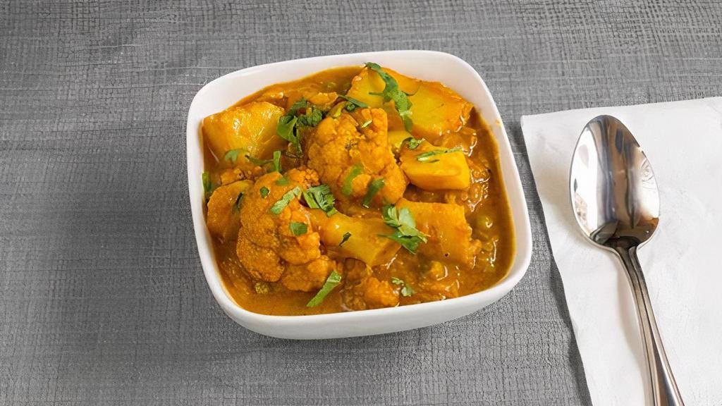 Aloo Gobhi · Potato and cauliflower curry cooked in traditional style.