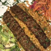 Adana Kebab · Skewered and grilled ground lamb, flavored with peppers and paprika.