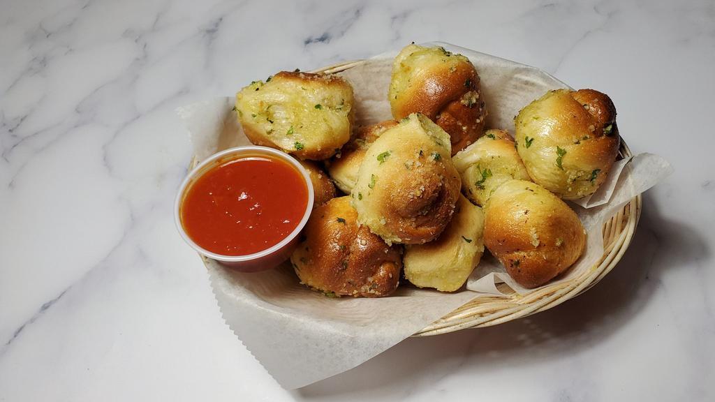 Garlic Knots · Homemade twisted dough baked with fresh garlic, extra virgin olive oil, Italian spices, and parmesan. Comes in 6 piece or 12 piece options.