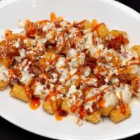 Buffalo Tots · Cajun spiced tater tots, blue cheese alfredo sauce, bacon bits and blue cheese crumbles with...