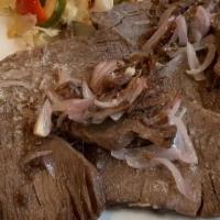 Carne De Res Frita / Fried Steak · Se sirve con arroz y habichuelas, tostones maduros, papas fritas o ensalada. / Served with r...