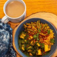 Palak Paneer Bowl · organic paneer chunks in spinach sauce on a bed of basmati rice with masala roasted Yukon go...