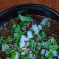 Birria · Beef cheek, broth, onions, cilantro, lime, tortilla.