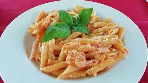 Penne · Penne pasta tossed in homemade sauce sprinkled with fresh basil.
