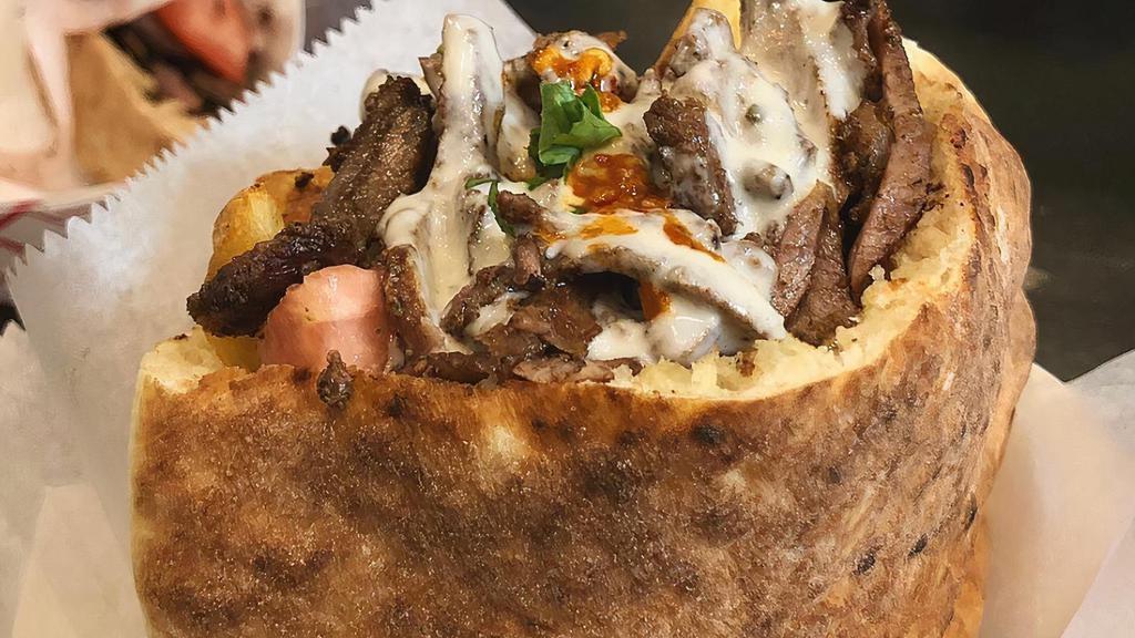 Beef Shawarma · Fire-roasted beef meat sliced, marinated with olive oil and Mediterranean spices.