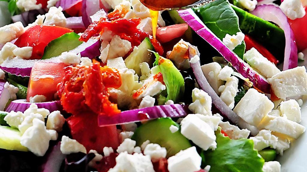 Mediterranean Crinkle Fries Salad · Diced cucumber , tomatoes , onion , feta cheese , olive oil mixed with our chef's secret inspired dressings and seasonings.
