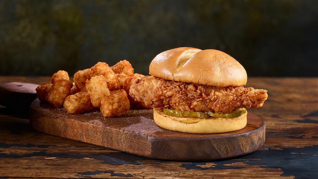 Saucy Fried Chicken Sandwich Combo · Fried Chicken breast tossed in your choice of sauce: Hot, Mild, Hickory Bourbon BBQ, Nashville Hot, Garlic Parmesan, So Sassy Honey.  Add a slice of American or Cheddar Cheese.  Comes with a side of French Fries or Tater Tots, and a beverage.