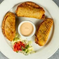 Empanadas · Pastry shell filled with cheese with choice of chicken or ground beef.