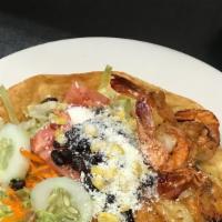 Taco Salad · Crispy flour tortilla bowl filled with black beans, lettuce, onion, corn, tomato, cucumber, ...
