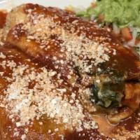 Chiles Rellenos · Battered poblano peppers stuffed with cheese and topped with ranchera sauce.