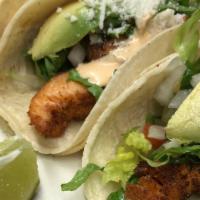 Tacos De Pescado · Tilapia, corn tortillas, lettuce, avocado, pico de gallo, chipotle mayo, Served with rice an...