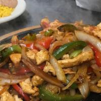 Fajitas Chicken · Onion, peppers and tomatoes in a skillet in any style, choice of corn or flour sautéed torti...