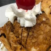 Fried Ice Cream · Scoop of vanilla ice cream rolled in corn flakes, lightly fried, whipped cream, chocolate sy...