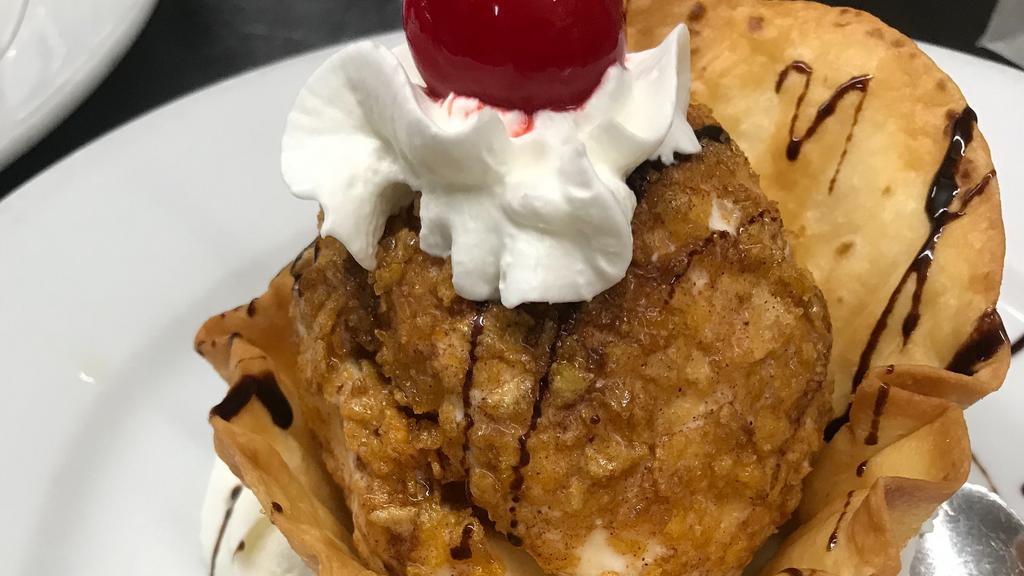 Fried Ice Cream · Scoop of vanilla ice cream rolled in corn flakes, lightly fried, whipped cream, chocolate syrup and a cherry.