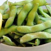 Edamame · Steamed edamame pods, salted, and served with a wedge of lemon.