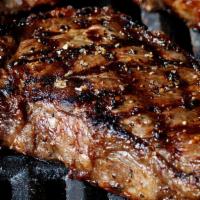 New York Strip · Center cut 14 oz strip grilled to your liking, topped with beer battered onion rings and ser...