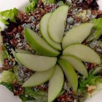 Apple Salad · Mixed greens topped with glazed walnuts, caramelized bacon, crumbly bleu cheese and sliced g...