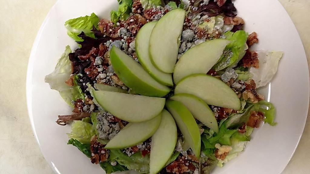 Apple Salad · Mixed greens topped with glazed walnuts, caramelized bacon, crumbly bleu cheese and sliced granny smith apples.