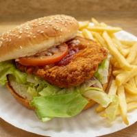 Spicy Chicken Sandwich · With French fries and can of soda.