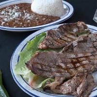 Carne Asada · (arroz y habichuelas) or (ensalada y tostones)/Grilled beef with (rice and beans) or (salad ...