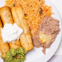 Chimichangas · Two crisp flour tortillas stuffed with beef or chicken topped with sour cream and guacamole.