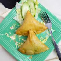 Vegetable Samosa · Vegan upon request – Crisp pastry filled with potatoes, peas, spices and deep fried.