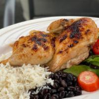 ½ Roast Chicken · Roast chicken served with rice, salad, and beans