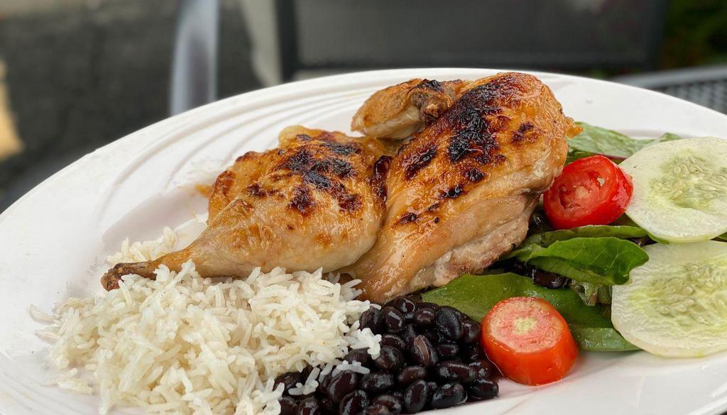 ½ Roast Chicken · Roast chicken served with rice, salad, and beans