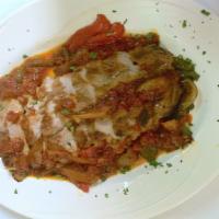 Lomo De Cerdo A La Plancha · Grilled pork loin served with onions and peppers in tomato sauce