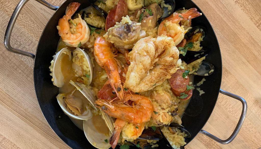 Paella Valenciana · A combination of mixed seafood, chicken, and Spanish sausages all cooked in saffron rice