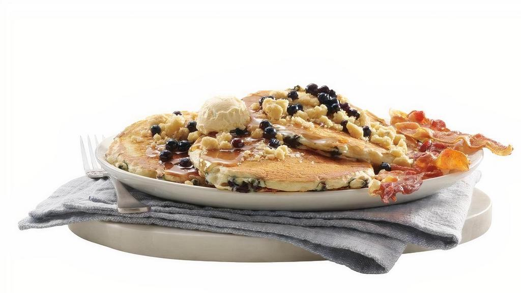 New! Blueberry Muffin-Top Pancakes · Get 3 fluffy pancakes filled with plump, wild blueberries, topped with our house made crumb topping and extra blueberries, served together with your choice of Applewood-smoked bacon and sausage.