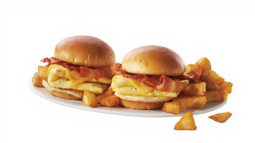 New! Breakfast Sliders · Sandwich your appetite between 2 mini Brioche buns filled with a hearty portion of scrambled eggs, American cheese, and Applewood-smoked bacon.  Served with your choice of home fries or grilled breakfast potatoes with peppers and onions.