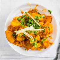 Aloo Gobi · Cauliflower with potatoes garnished tomato and Indian spices.