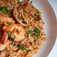 Youvetsi Thalassina · Calamari, shrimp and octopus with herbs and orzo in fresh tomato sauce.