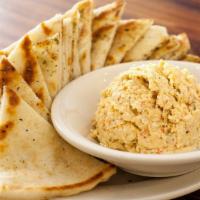 Tyrokafteri · Vegetarian, gluten-free. Spicy feta dip, served with warm pita bread.