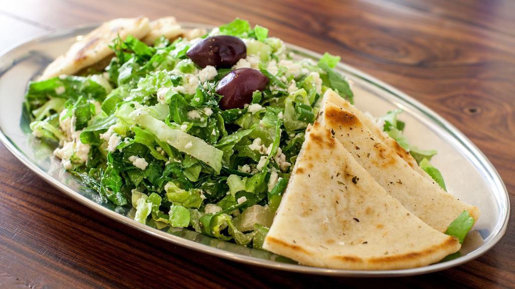 Prasini · Green salad with greens, scallions, dill, and crumbled feta.