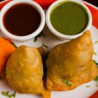 Samosas · Spiced potatoes and peas in fried dough