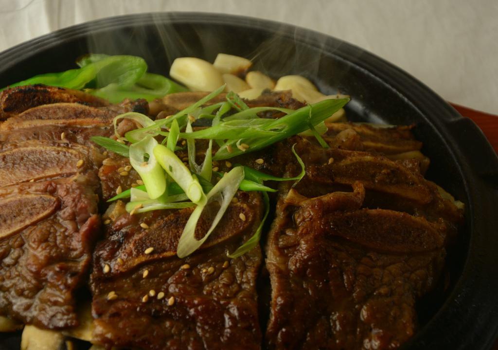 A Galbi (Kbbq) · marinated beef short ribs grilled over fire served on hot plate