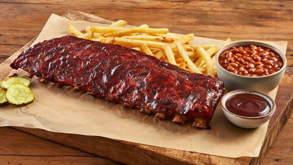 Full Rack Baby Back Ribs · Fall-off-the-Bone goodness, a full rack served with your choice of sauce: Classic BBQ, Alabama white sauce or Carolina BBQ. With 2 sides and 3 pickle chips you won’t go home hungry.