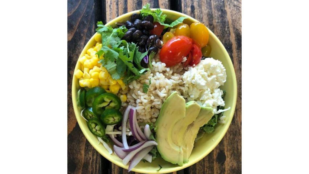 Southwest Buddha Bowl · Grape tomatoes jalapenos red onions corn avocado black beans cilantro feta cheese baby spinach cabbage brown rice and cilantro pepita dressing
