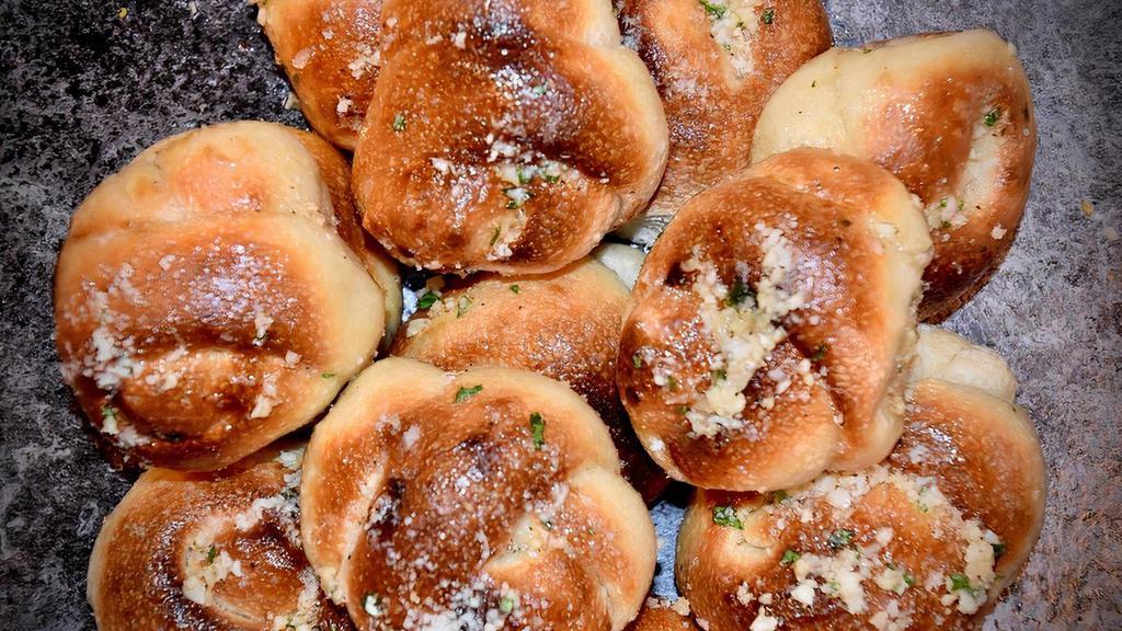 Garlic Knots · Fresh baked knot baked in our coal fired oven. Topped with garlic, olive oil, fresh parsley and romano cheese