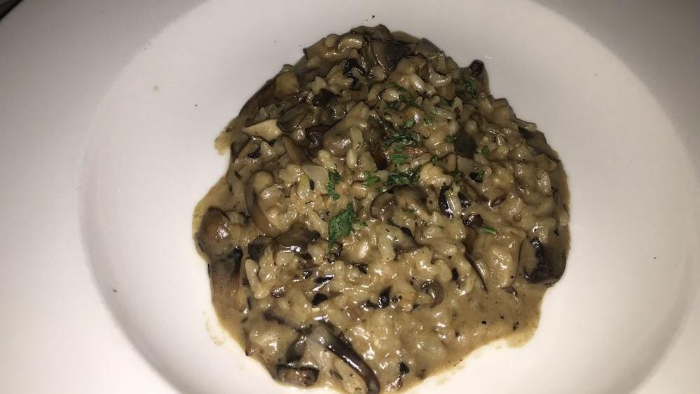 Risotto Porcini · Arborio rice with peas and porcini mushrooms.