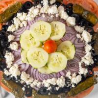 Greek Salad · Crisp lettuce, feta cheese, stuffed grape leaves, tomato, olives and onion.