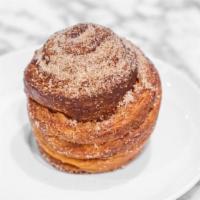 Cinnamon Kouign Amann · A buttery croissant rolled in cinnamon sugar to form a caramelized crust creating pockets of...