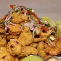 Peruvian Jalea Mixta · Fried seafood served with yuca, salsa criolla and tartare sauce.